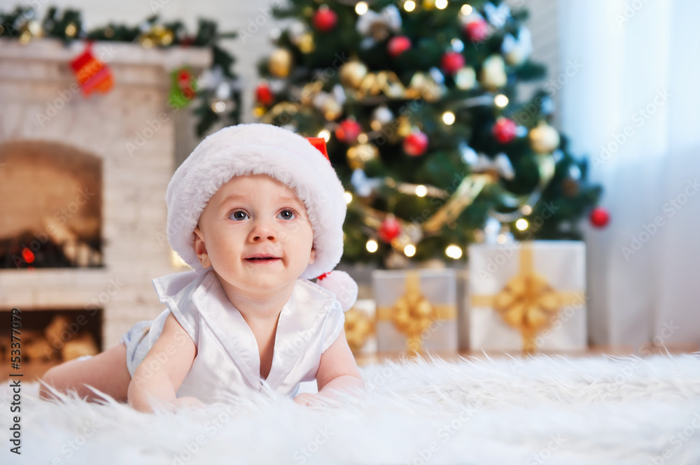 Kid in Santa hat, in a holiday room Kid in Santa hat, in a holiday room