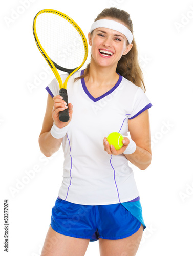 Portrait of smiling female tennis player with racket and ball © Alliance