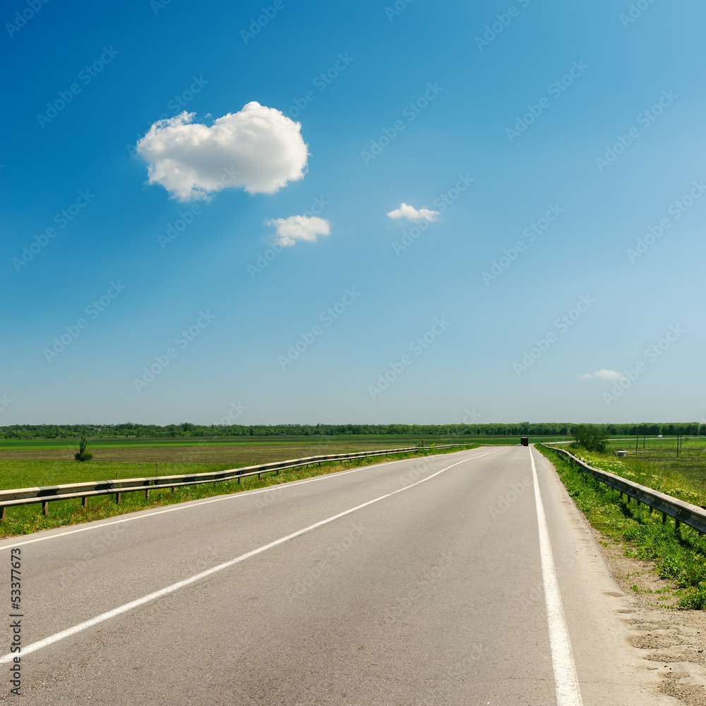 asphalt road to horizon under blue sky