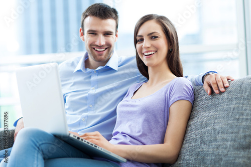 Couple on sofa with laptop