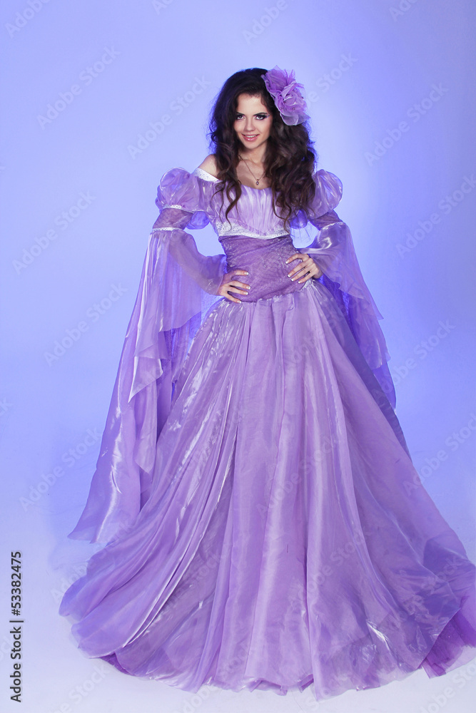 Beautiful woman model posing in Long Chiffon dress over purple i Beautiful woman model posing in Long Chiffon dress over purple i