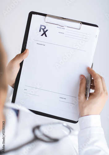 male doctor writing prescription paper