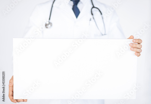 doctor holding blank white banner photo