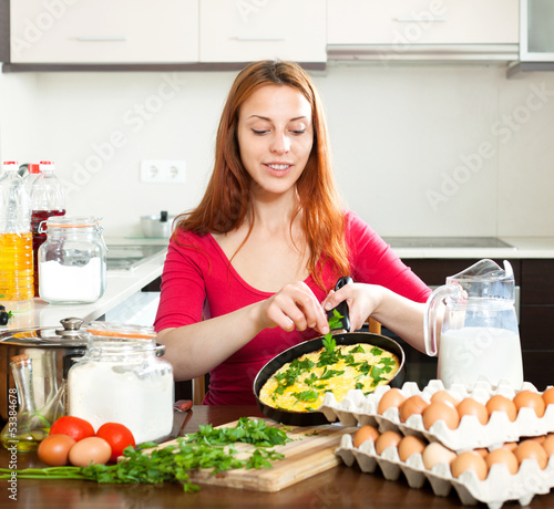  woman  with  scrambled eggs at home photo