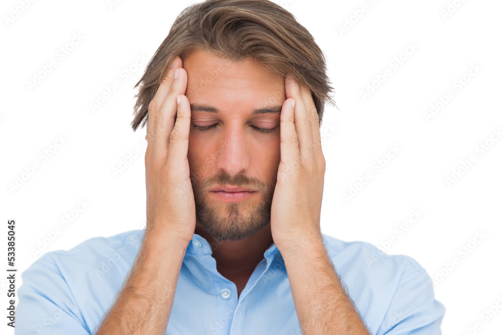 Man touching his temples to calm a headache Man touching his temples to calm a headache