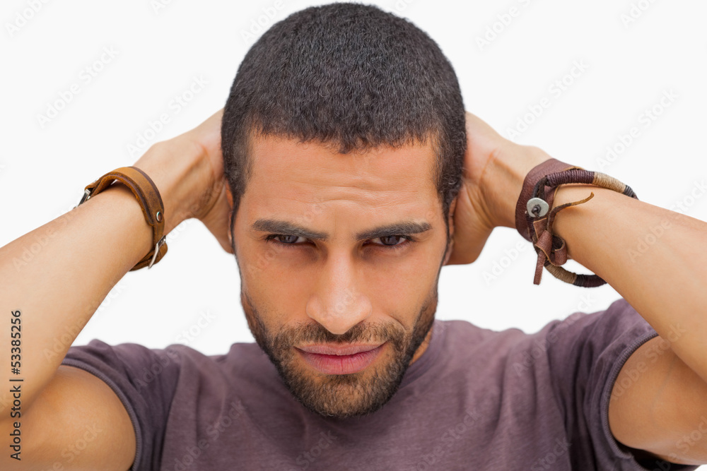 Obraz premium Handsome man posing with hands on head