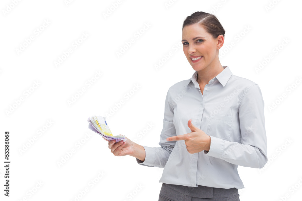 Happy businesswoman pointing to money in her hand Happy businesswoman pointing to money in her hand