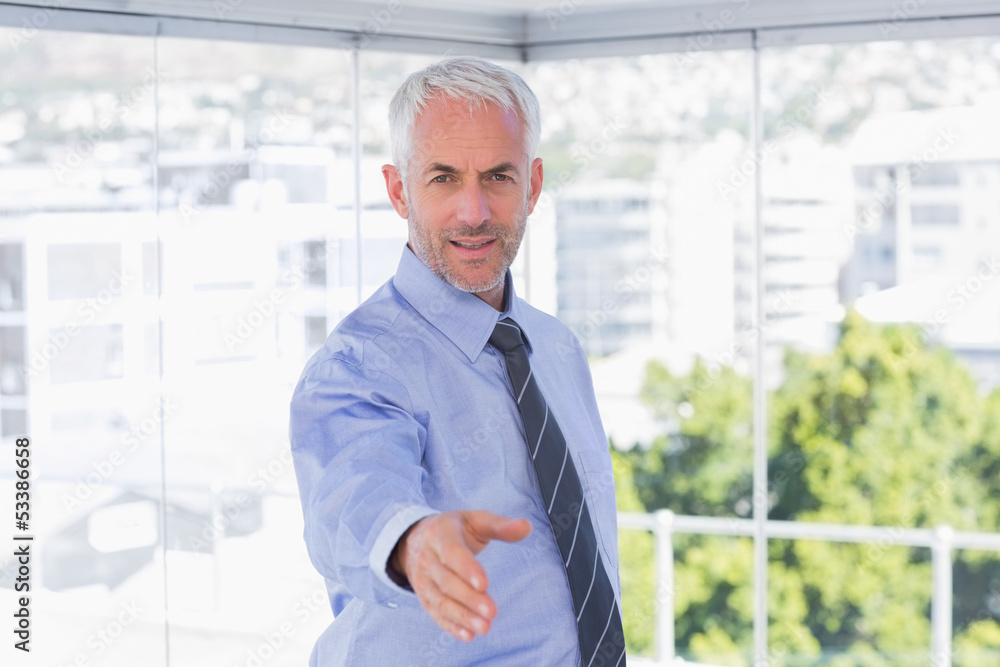 Happy businessman extending arm for handshake Happy businessman extending arm for handshake