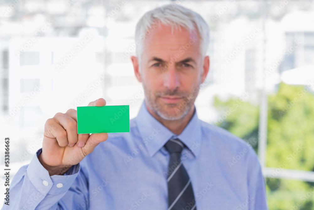 Businessman showing green business card Businessman showing green business card