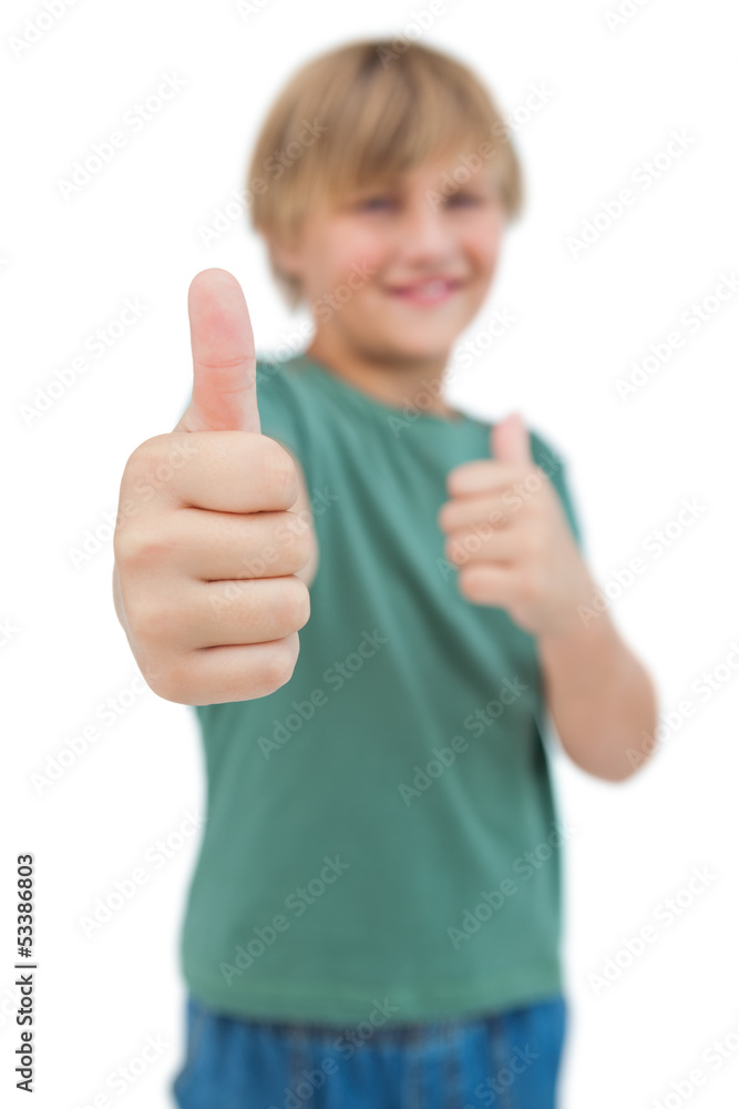 Blonde boy giving thumbs up focus shot Blonde boy giving thumbs up focus shot