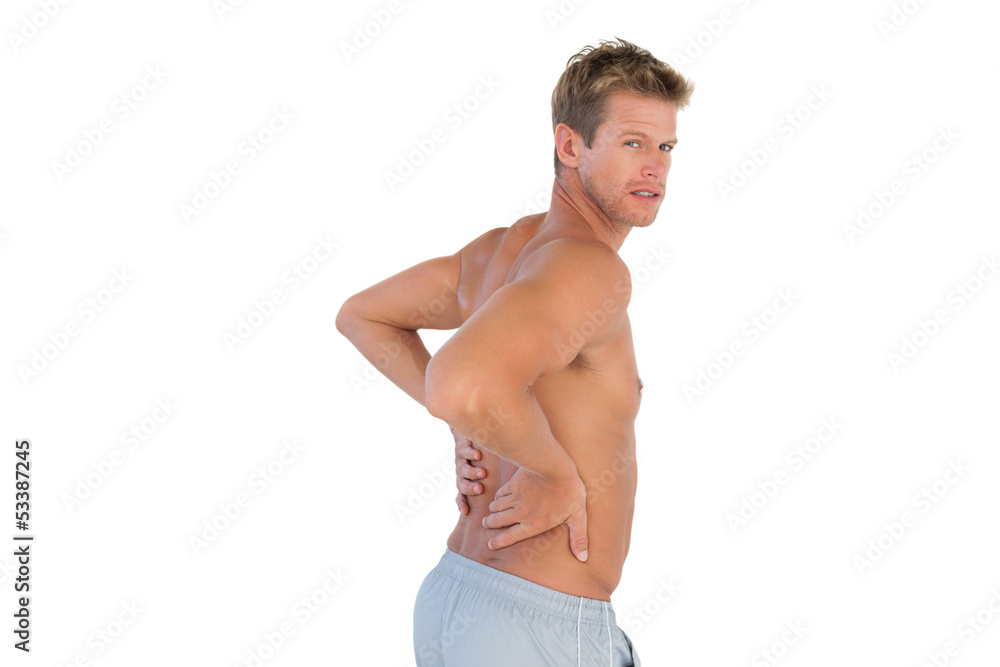 Shirtless handsome man suffering from back pain Shirtless handsome man suffering from back pain