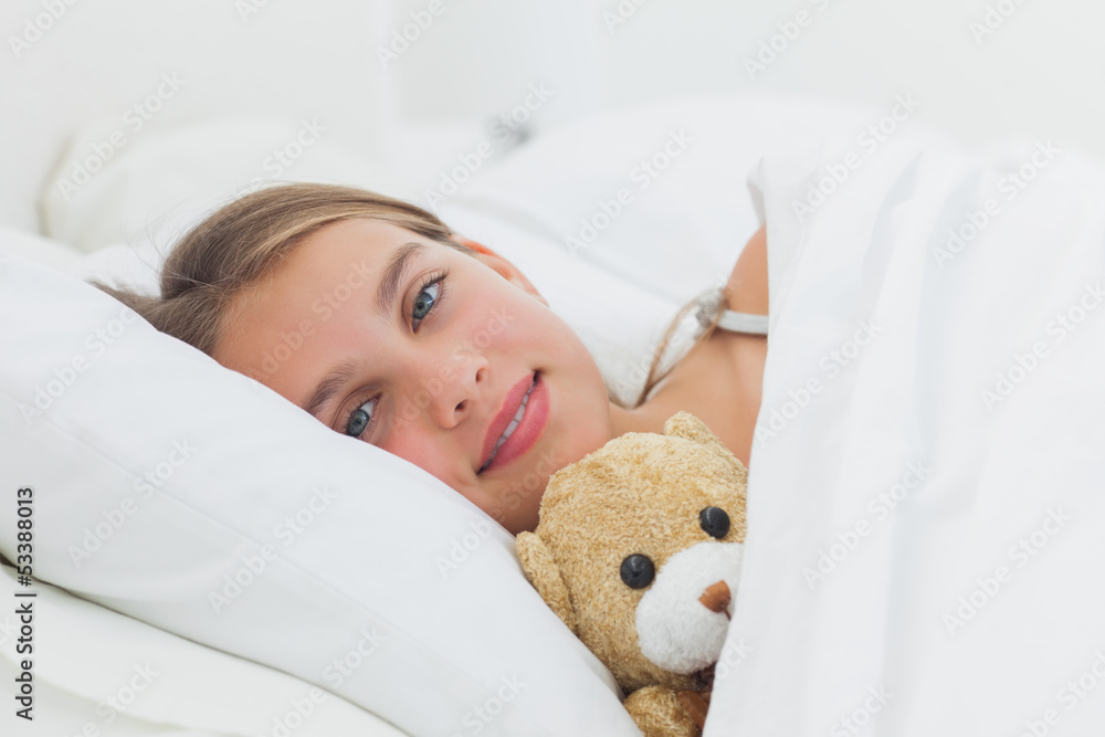 Cheerful girl relaxing with her teddy bear Cheerful girl relaxing with her teddy bear