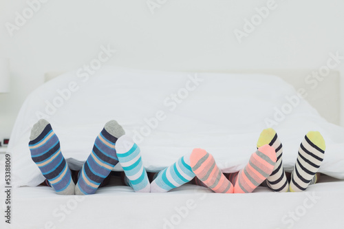 Familys feet in stripey socks