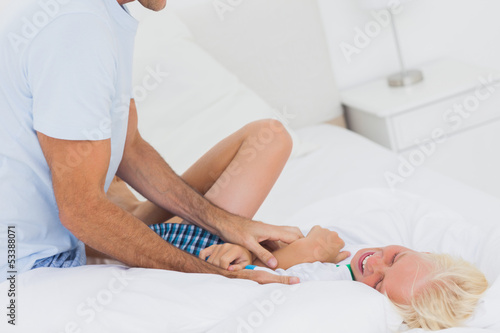 Fotografie Father tickling his son