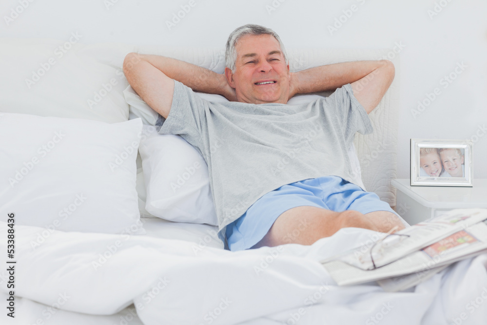 Retired man relaxing in bed Retired man relaxing in bed