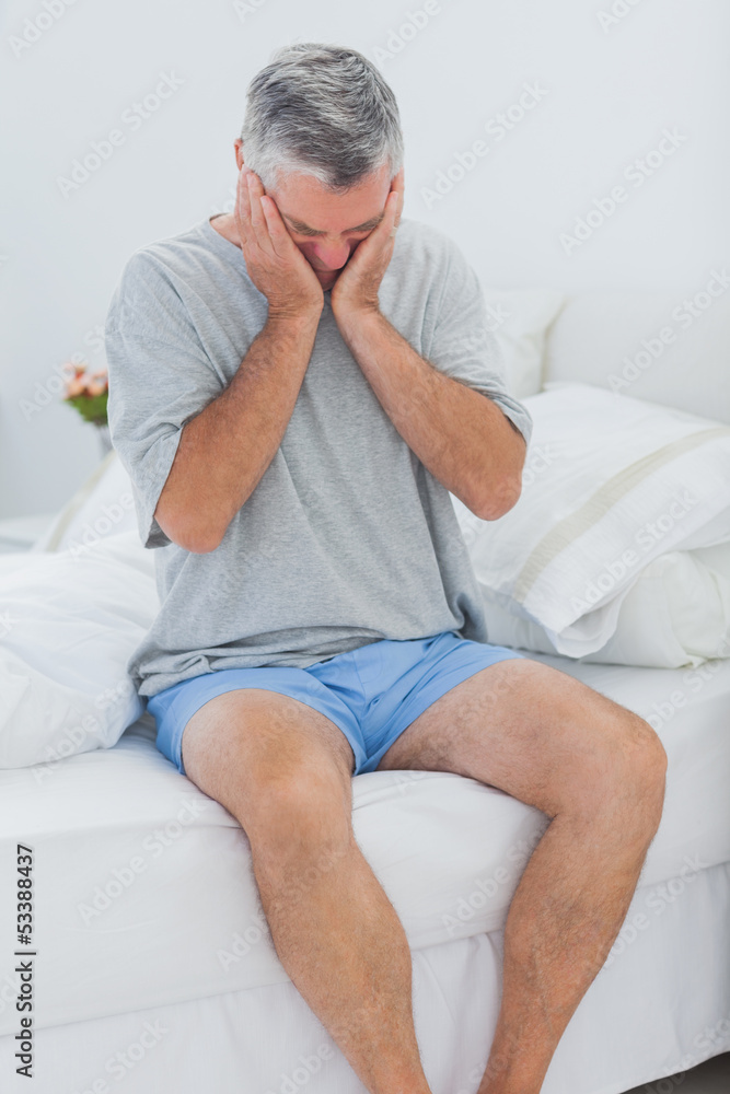 Man getting off the bed Man getting off the bed