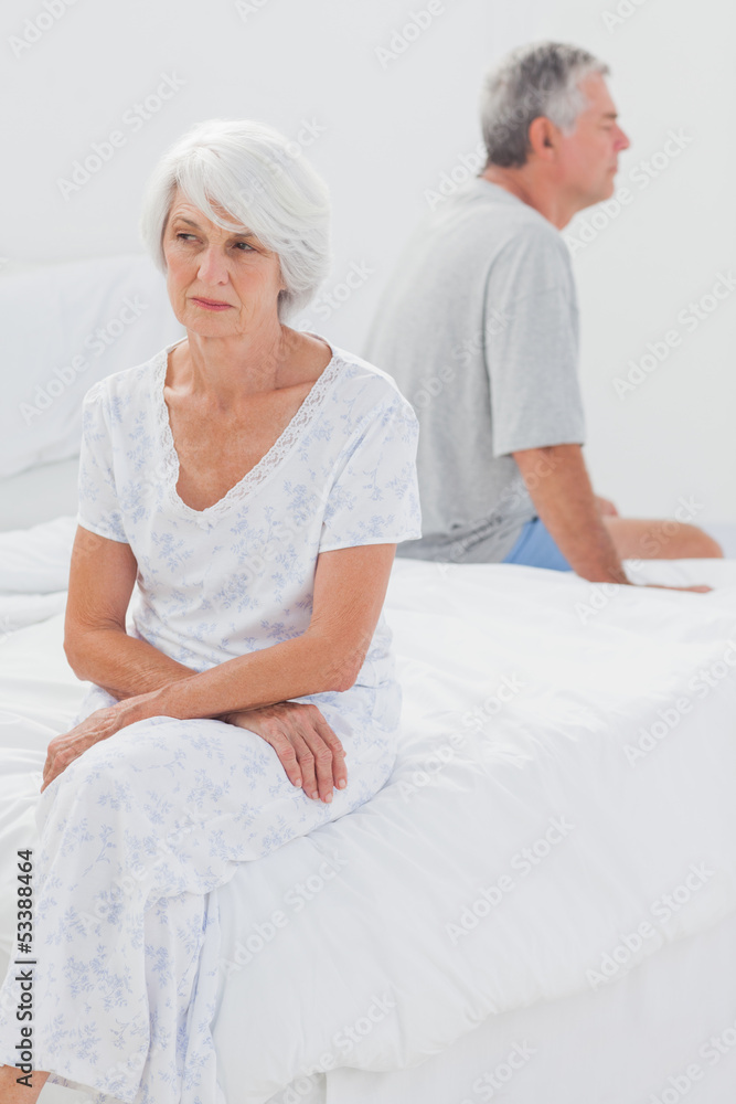 Angry woman sulking in bed during a conflict Angry woman sulking in bed during a conflict