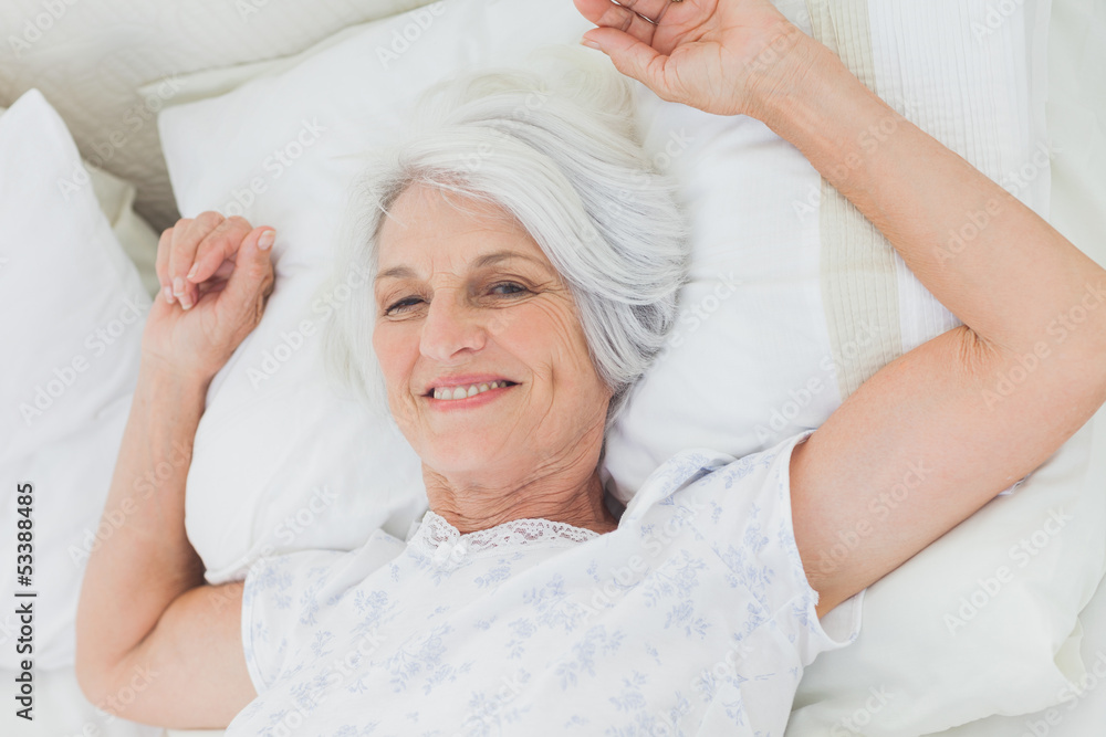 Woman waking up in bed Woman waking up in bed
