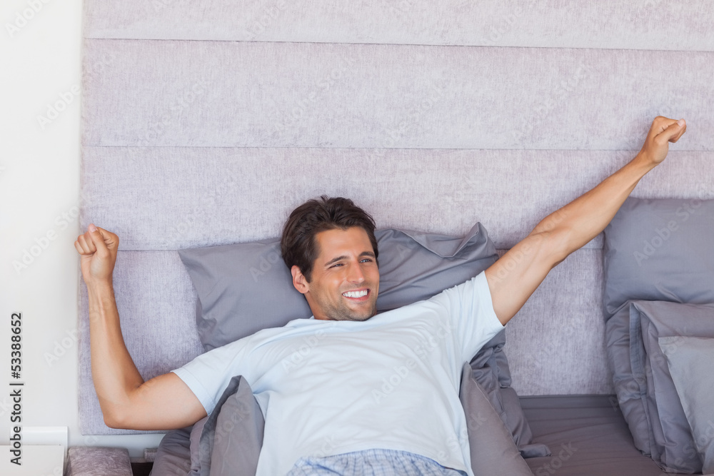 Handsome man waking up and stretching Handsome man waking up and stretching