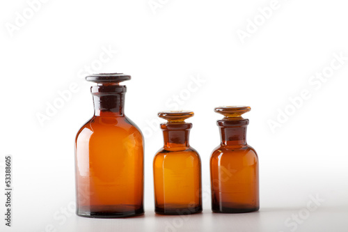 Small chemical glass bottles on white background