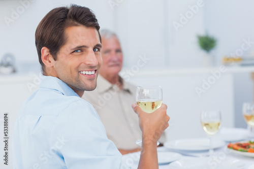 Attractive man holding a glass of white wine