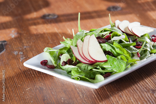 Fresh organic spinach artisan salad with pears and cranberries photo