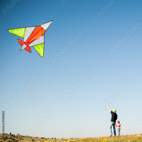 Dad and his daughterflying a kite