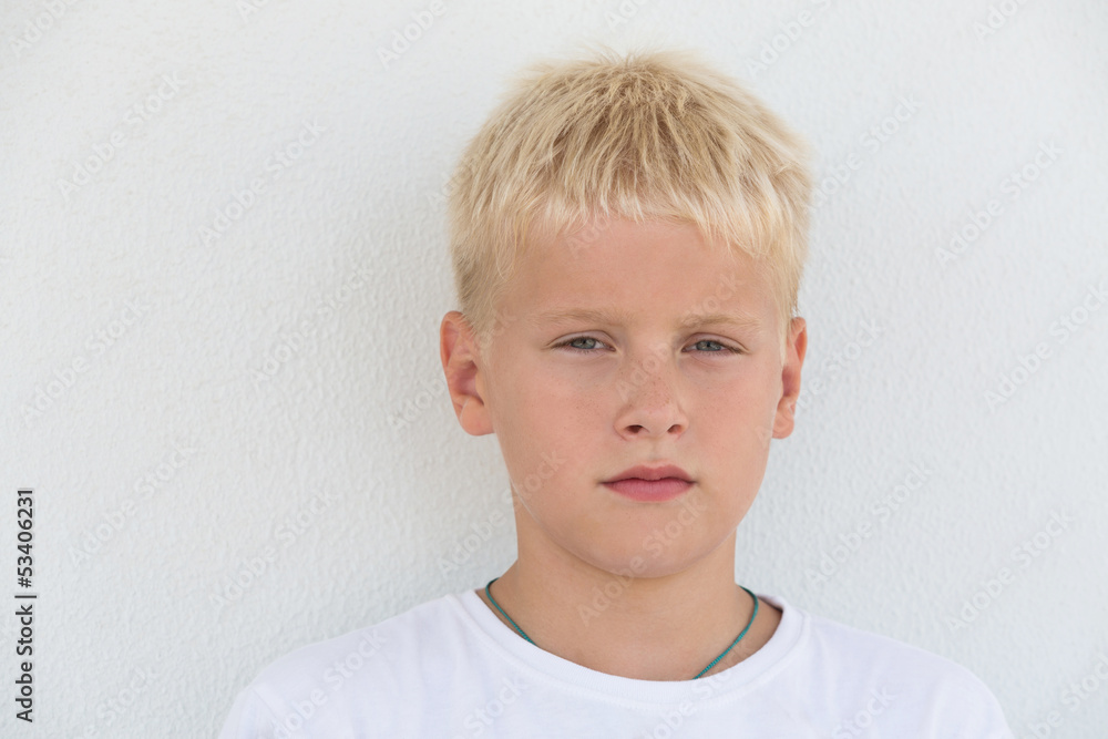 Portrait of young boy with focused look in white t-shirt Portrait of young boy with focused look in white t-shirt