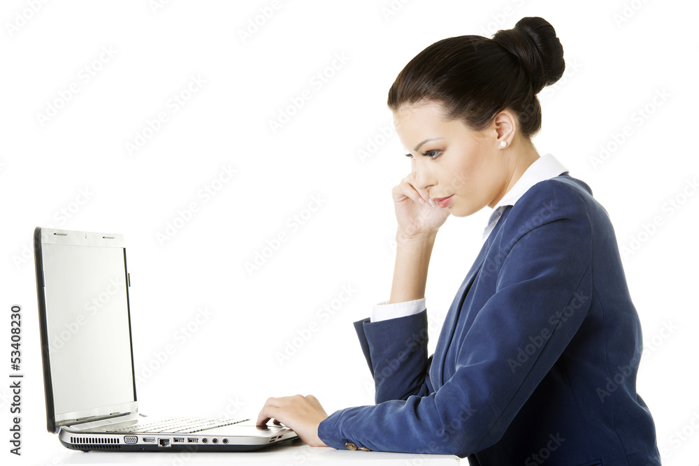 Beautiful brunette businesswoman working on laptop Beautiful brunette businesswoman working on laptop
