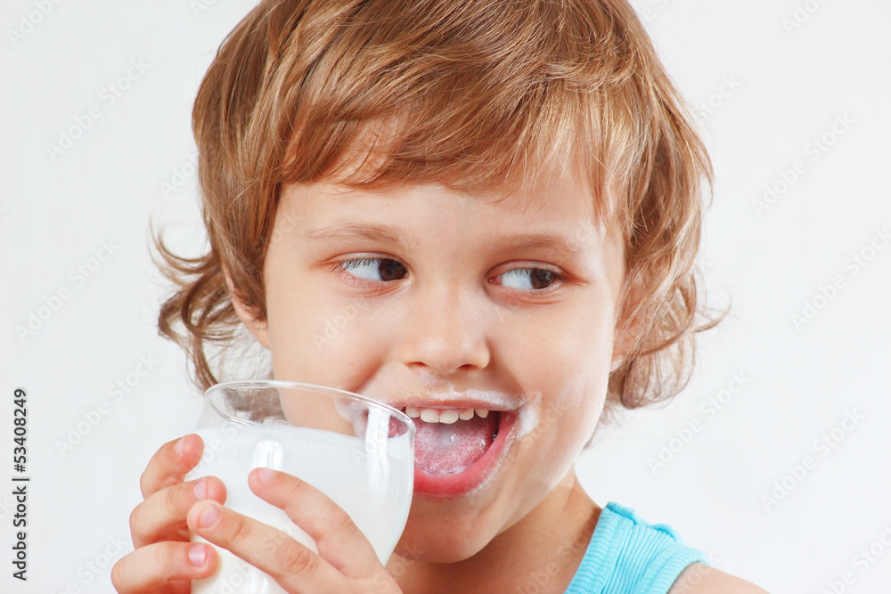 Beautiful blonde child drinking a fresh milk on white background Beautiful blonde child drinking a fresh milk on white background