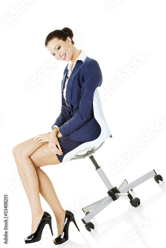 Beautiful successful businesswoman sitting on ofice chair