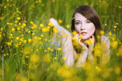 Beautiful woman in flowery meadow