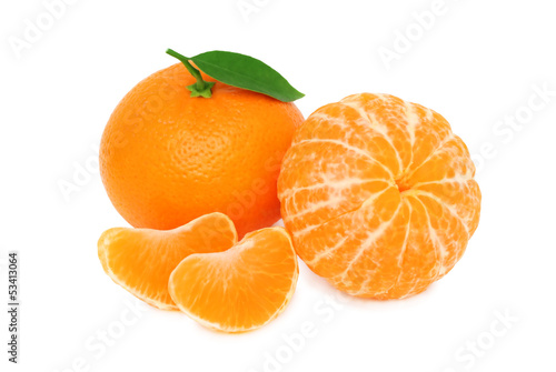 Two ripe mandarins and slices with green leaves on white backgro