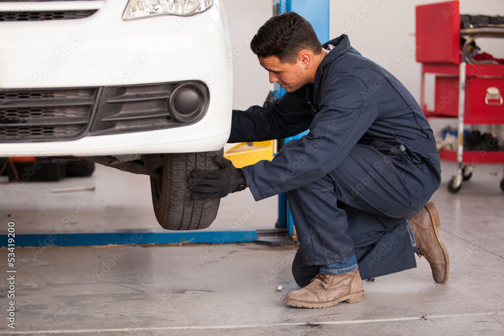 Changing a tire at an auto shop Changing a tire at an auto shop