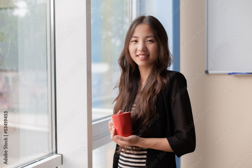young girl holding a cup