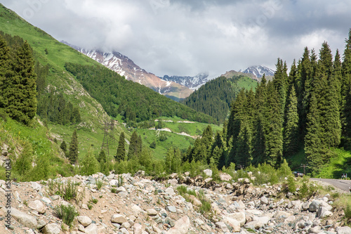 Road on  Big Almaty Lake, nature  green mountains and blue sky photo