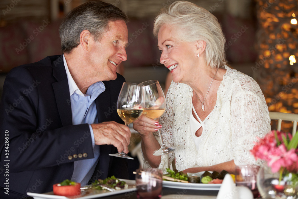 Senior Couple Enjoying Meal In Restaurant Senior Couple Enjoying Meal In Restaurant