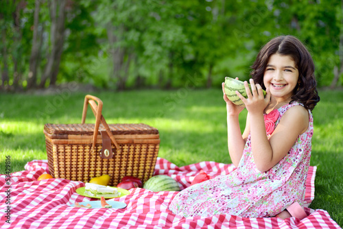 little girl with large slice of watermelon