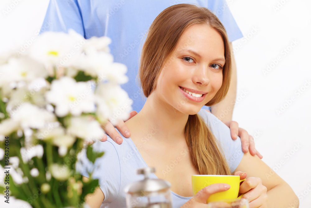 Beautiful young woman drinking tea