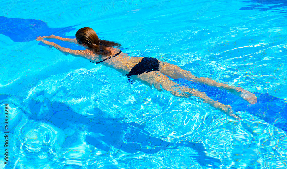 Young woman swimming in the pool