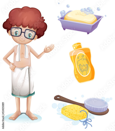 A boy with a soap, shampoo, brush and sponge