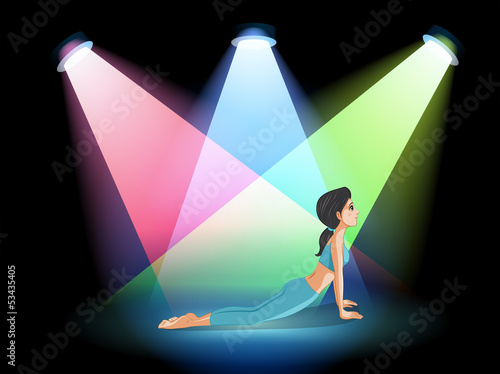 A lady exercising in the middle of the stage