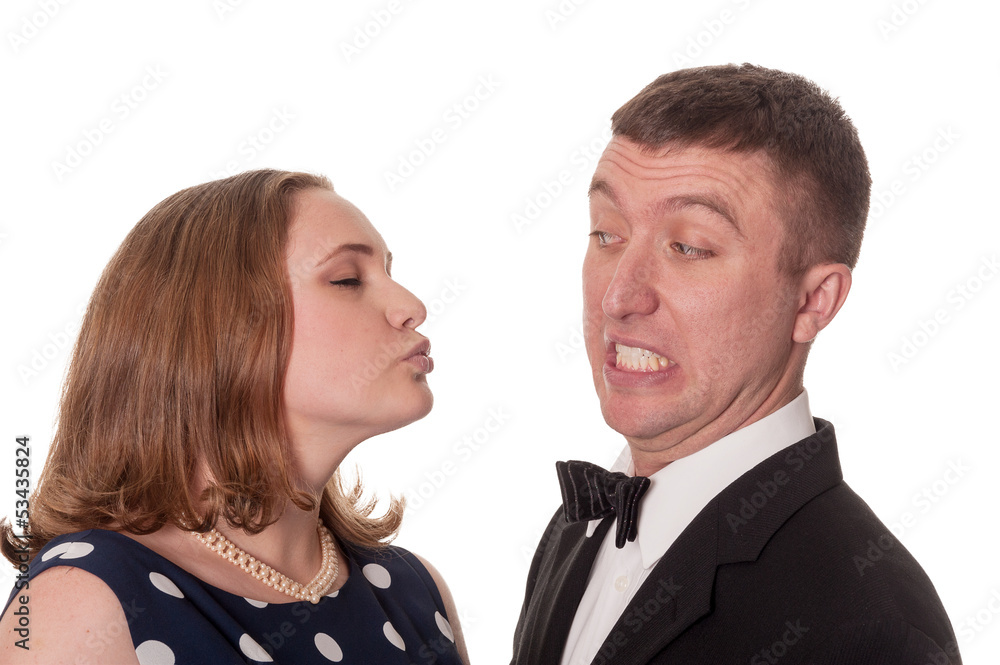 Man does not want kiss from woman - isolated on white Man does not want kiss from woman - isolated on white