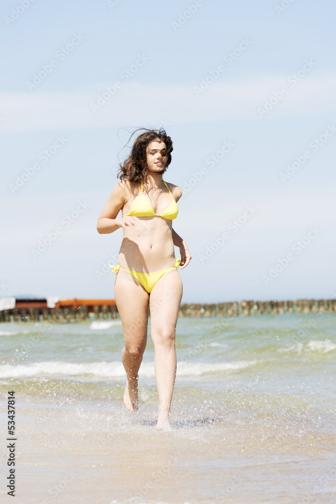 happy woman running on the beach