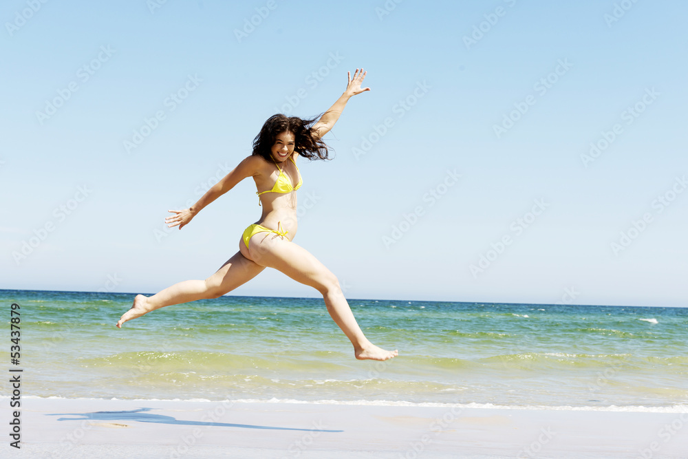 Happy girl jumping on the beach Happy girl jumping on the beach