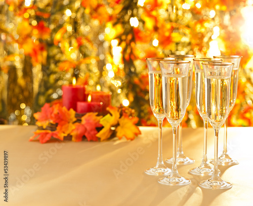 Champagne glasses for reception in front of autumn background
