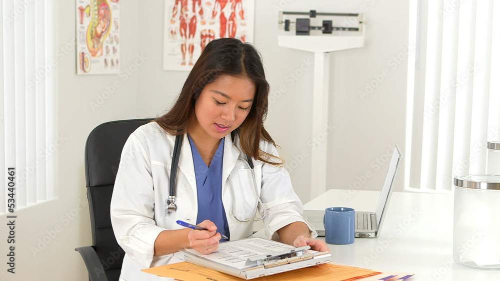 Female Asian doctor talking to client at desk Female Asian doctor talking to client at desk