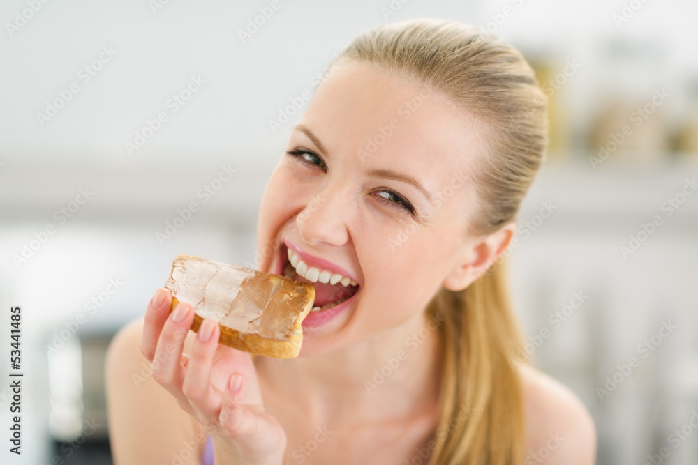 Happy teenage girl eating toast with chocolate cream Happy teenage girl eating toast with chocolate cream