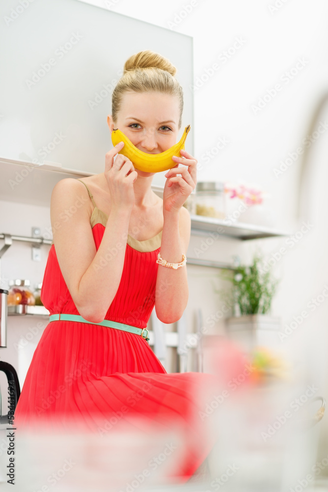 Happy teenage girl smiling with banana Happy teenage girl smiling with banana