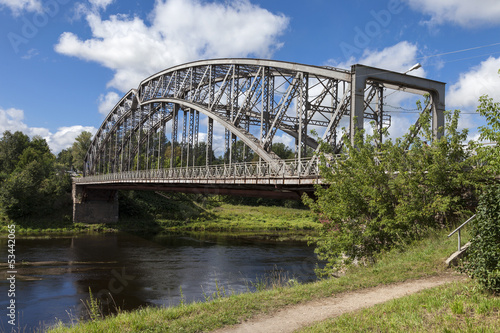 Steel Arch Bridge on river Msta. Novgorod region, Russia